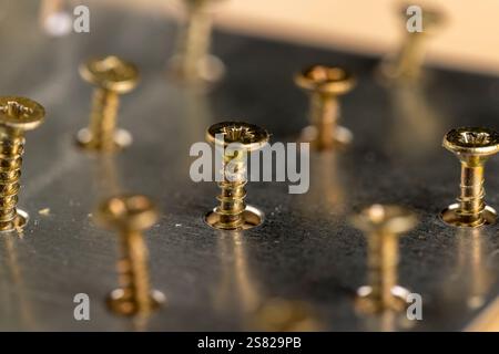 metal silver corner with a lot of holes for connecting wooden parts with screws, metal building products for connecting wooden structures Stock Photo