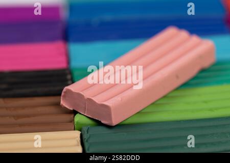 plasticine of different colors for modeling closeup, a simple colored plasticine that is used in children's creativity Stock Photo