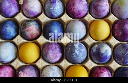 Easter eggs. Organized in a cardboard egg tray. Colorful, bright, handmade, decorated. Sustainable cardboard packaging Stock Photo