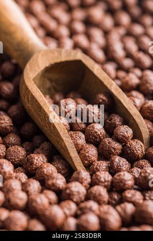 Breakfast cereal chocolate balls in a wooden scoop. Stock Photo