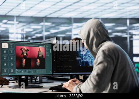 Engineer in data center making generative artificial intelligence website generating videos using diffusion model algorithms. Hooded man coding AI virtual assistant producing clips Stock Photo