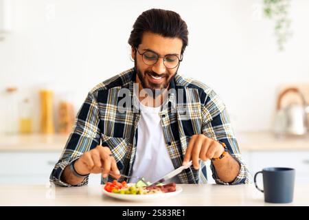 Positive arab guy having healthy breakfast at home Stock Photo