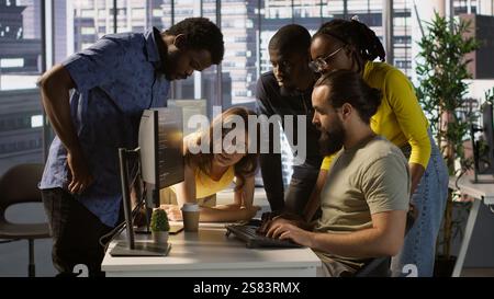 Programmers gathered together to conduct code review to fix errors, identifying technical issues with company software. Team of developers doing brainstorming, optimizing code, camera A Stock Photo