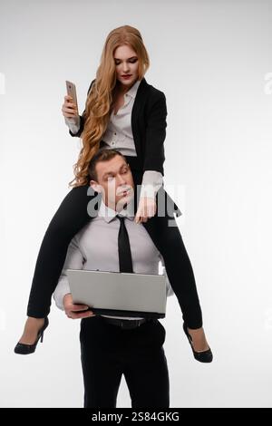 Couple engages in a playful business moment during a sports-themed photoshoot Stock Photo