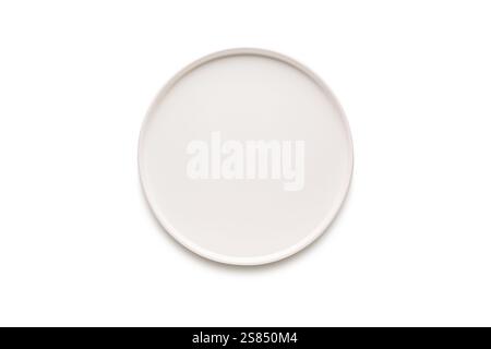 Top view of empty ceramic white plate on white background Stock Photo