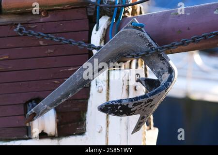 Anchor of a ship hanging on a chain Stock Photo