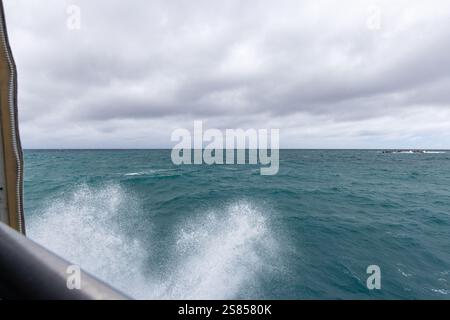 Breaking waves on ferry on the way from Praslin to La Dique, Seychelles Stock Photo