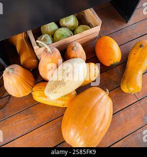 Pumpkins on wooden floor. Big orange vegetables for sale at local farmers market. Stock Photo