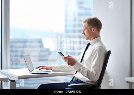 Busy professional young business man executive working in modern office. Stock Photo