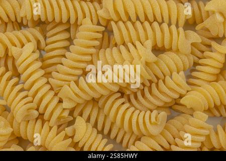 pile of raw fusilli pasta, close-up, isolated on a white background Stock Photo