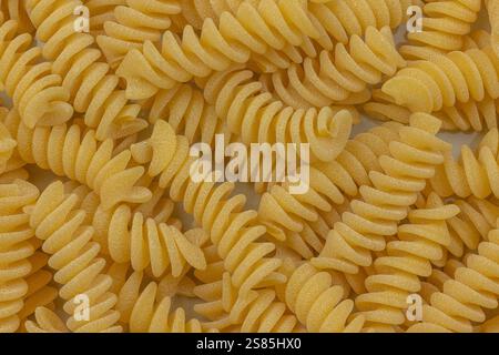 pile of raw fusilli pasta, close-up, isolated on a white background Stock Photo