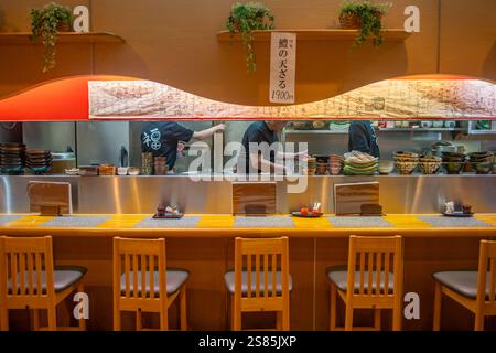 View of chefs busy at work through restaurant window in Omicho Market, Kanazawa City, Ishikawa Prefecture, Honshu, Japan Stock Photo