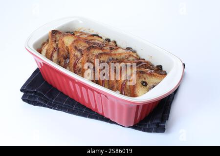 Delicious bread pudding in baking dish isolated on white Stock Photo