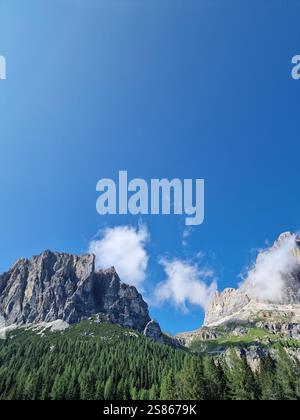Sharp and towering rock peaks Dolomites rise dramatically against sky ...