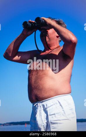 Man with binoculars Stock Photo