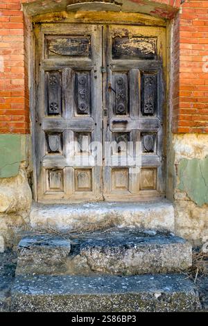 Old, disused, wooden panelled door, Monzón de Campos, Palencia Province, Castile y Leon, Spain Stock Photo