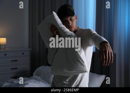 Young man suffering from sleepwalking at home Stock Photo