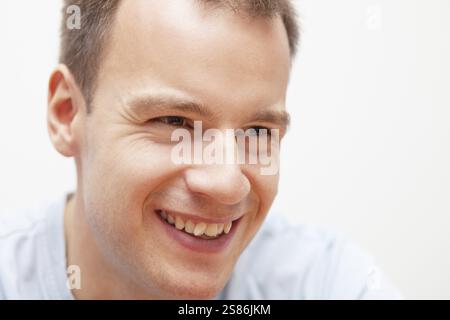 Portrait of handsome smiling young man, selective focus, Germany, Europe Stock Photo