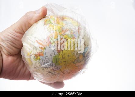 World globe in plastic bag isolated on white background Stock Photo