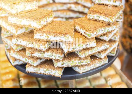 Turkish traditional dessert Kadayif baked in syrup served with nut powder Stock Photo