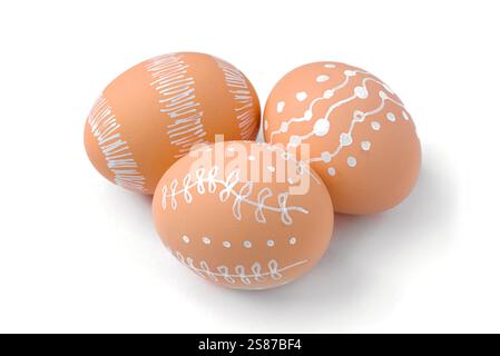 Natural brown Easter eggs with white minimalist patterns isolated on a white background Stock Photo
