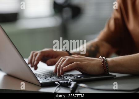 Cropped shot of male programmer typing on laptop keyboard coding in office, copy space Stock Photo