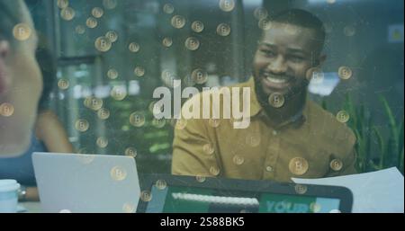 Image of bitcoins over diverse business people in office Stock Photo