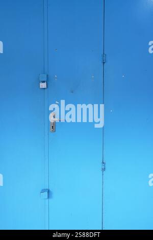 Blue rustic metal gate, folding door, industrial, old school, vintage, heritage door Stock Photo