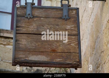 DARK WOODEN HANGING SIGN WITHOUT INSCRIPTION Stock Photo