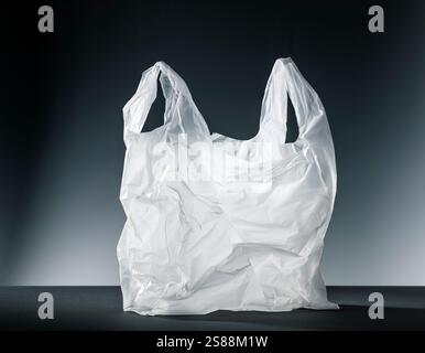 White plastic carrier bag against a dark background Stock Photo