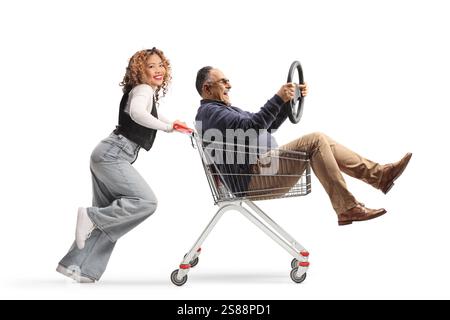 Asian woman running and pushing a mature man inside a shopping cart solated on white background Stock Photo