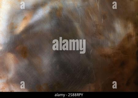 Aggressive rough copper background with reflections of orange and blue. Design background. Natural left lighting. Copy space. Stock Photo