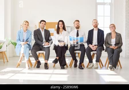 Smiling hr leaders sitting in office room for interview, diverse businesspeople team confident  Stock Photo