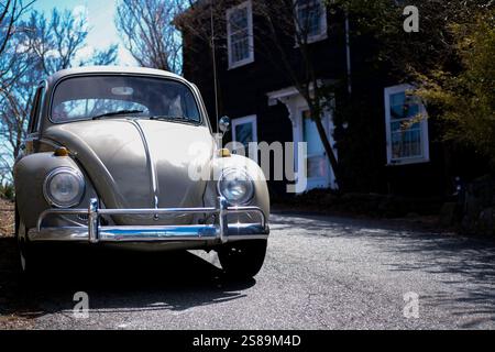 A classic Volkswagen Beetle parked outside a colonial home in Marblehead, MA Stock Photo