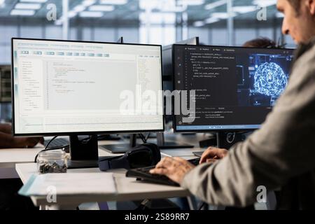 System administrator doing data center automation using AI and machine learning tools. IT specialist integrating artificial intelligence driven automation in server room operations Stock Photo