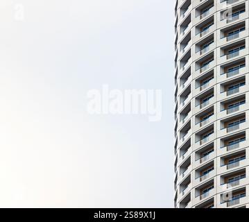 White skyscrapers of houses, with balconies, repeated in the form of a pattern, with copy space, white background Stock Photo