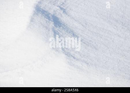 lines of light and shadow on grainy white snow surface Stock Photo