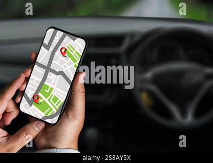 gps map ,man using a smartphone displaying a map in a car gps navigation system Stock Photo