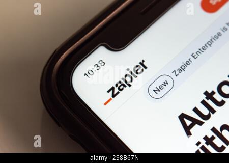 Website of Zapier is displayed on an iPhone. Zapier is a platform that connects apps and automates workflows, by creating "Zaps" Stock Photo