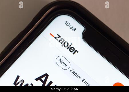 Website of Zapier is displayed on an iPhone. Zapier is a platform that connects apps and automates workflows, by creating "Zaps" Stock Photo