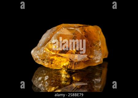 Closeup rough uncut citrine gemstone on dark background Stock Photo