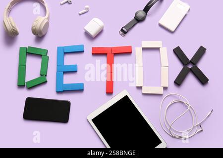 Word DETOX made of colorful letters and different gadgets on lilac background Stock Photo