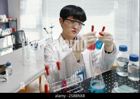 Conducting Scientific Experiment in Modern Laboratory Setting Stock Photo