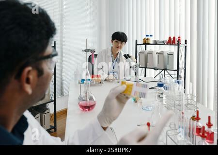 Researchers Analyzing Lab Samples in Scientific Laboratory Stock Photo
