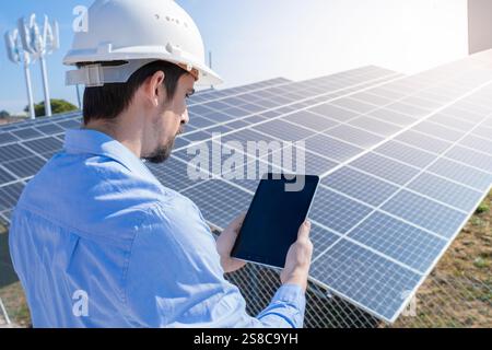 As a Renewable Energy Technician, you will be responsible for carefully monitoring solar panels Stock Photo