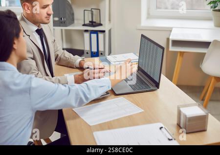 Colleagues using laptop, watching screen to check market growth, profit, trading, business trader Stock Photo