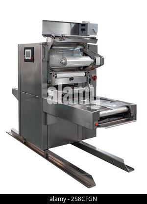 Isolated food packaging machine. Automatic sealing machine technology. Stock Photo