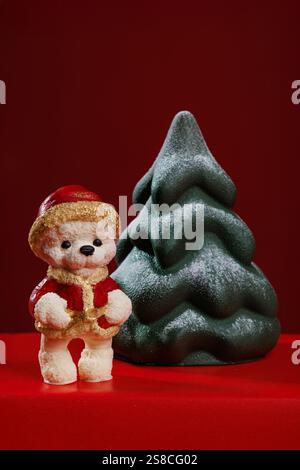 Christmas chocolate figures - bear and Christmas tree on a red background Stock Photo