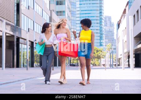 Three Happy Women Shopping and Strolling Outdoors. Stock Photo