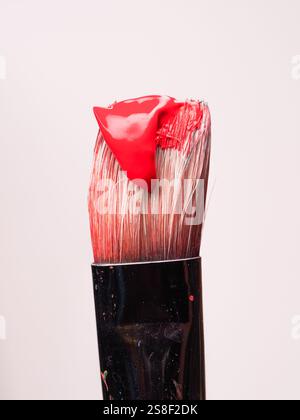 Paintbrush with red paint on a white background Stock Photo